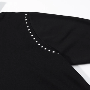 Women's black hoodie with stylish silver rivet studs along the seam and knit texture