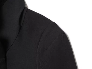 Detailed view of the shoulder stitching and heavy matte fabric on this black blazer
