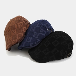Retro unisex ivy caps in brown, blue and black with textured letter embossed patterns