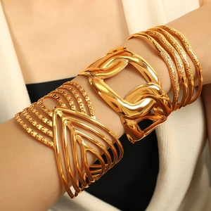 Exaggerated gold cuff bracelet set with 18K plating, featuring textured hammered finish