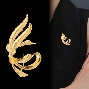 Elegant gold ribbon brooch with brushed texture shown on black blazer lapel for women