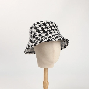 Detailed view of black and white houndstooth pattern on thick winter bucket hat