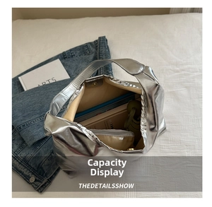Interior detail of large silver metallic tote bag showing spacious capacity and inner pouch