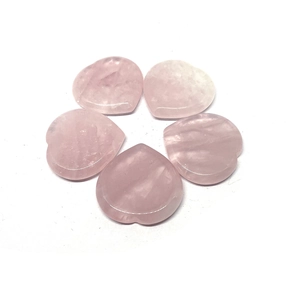 Detailed view of five smooth heart-shaped pink quartz thumb stones on a white background