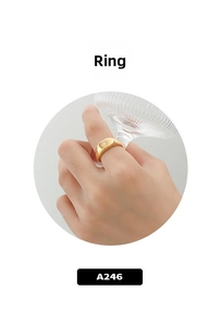 Close-up of golden signet ring featuring an engraved starburst and sparkling zircon
