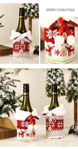 Detail of knitted Christmas wine bottle cover with faux fur collar and elk snowflake pattern