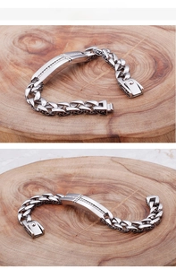 Macro view of men's titanium steel cross bracelet with cubic zirconia and vintage patterns