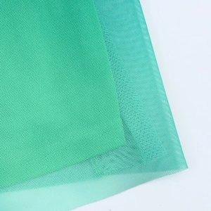 Close-up of green mesh fabric showing detailed breathable net texture and woven material