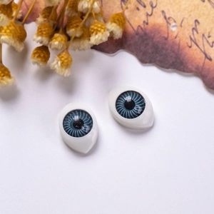 Detailed close-up of 12x16mm blue-grey acrylic doll eyes with realistic spiral texture