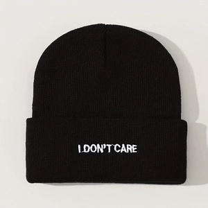 Black knit beanie with I DON'T CARE embroidery in a minimalist autumn winter style