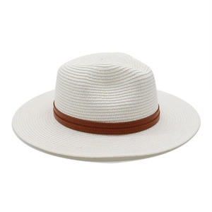 Détail de la texture d'un chapeau de paille blanc tressé avec ruban marron pour la protection