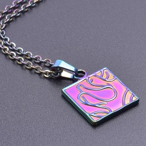 Macro view of square pendant with iridescent finish on stainless steel O-chain