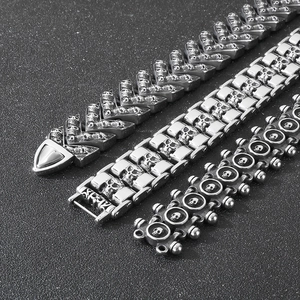 Detailed view of three punk skull bracelets with stainless steel chains in gothic style