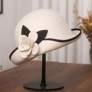 Elegant off-white wool felt fedora with 3D camellia flower and black contrast trim