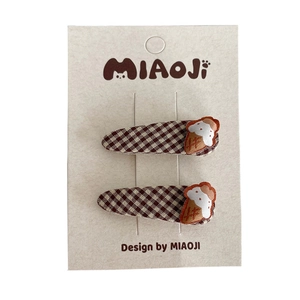 Brown checkered children hair clips with cute croissant embroidery on white card
