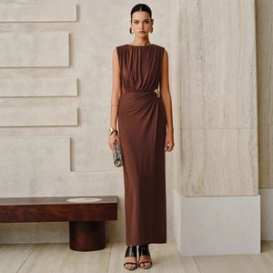 Detail shot of the elegant waist ruching and gold metal buckle on this brown knit maxi dress