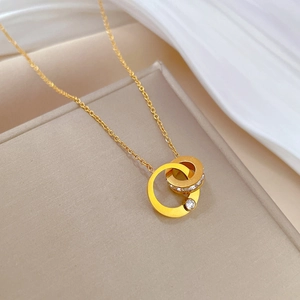 Detail of interlocking gold rings necklace with pavé crystals and single solitaire stone