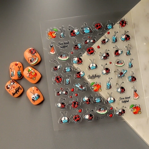 Close-up of 5D ladybug and watermelon nail stickers with sample manicures for nail art