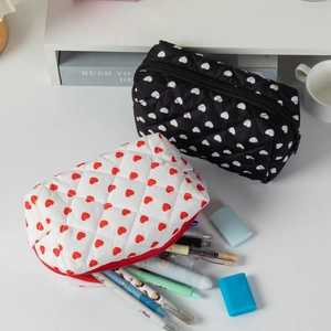 Detailed view of quilted cotton cosmetic bags with heart patterns and full stationery capacity