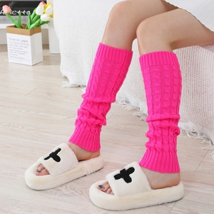 Detail of rose pink cable knit leg warmers with textured checkerboard pattern weaving