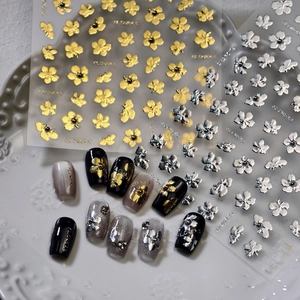Floral nail art stickers with metallic gold and silver flower patterns for manicures