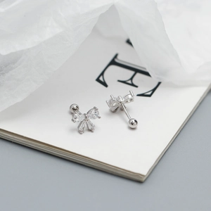 Macro shot of silver S925 bowknot earrings with cubic zirconia and screw back detail
