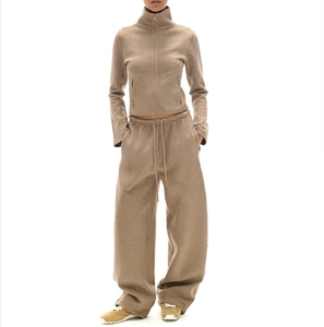 Detail of coffee brown zip-up jacket and wide-leg sweatpants set in retro style