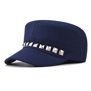 Detail of navy blue cadet cap featuring silver square metal rivets in punk style