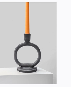 Macro detail of matte black Nordic candle holder featuring a textured ring-shaped design
