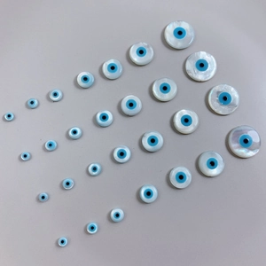 Macro shot of mother-of-pearl evil eye beads in multiple sizes for DIY jewelry