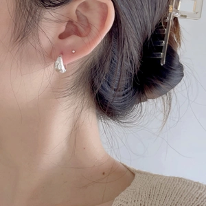 Elegant 925 sterling silver U-shaped hoop earrings with textured finish on model