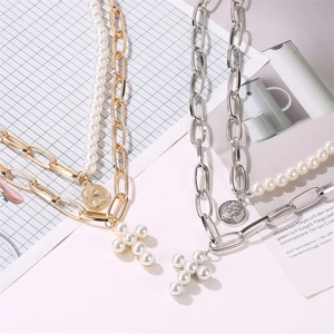 Layered gold and silver portrait coin necklaces with pearl cross pendants in retro style