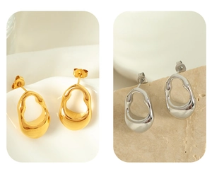 Close-up of irregular minimalist hollow earrings in gold and silver metallic finishes