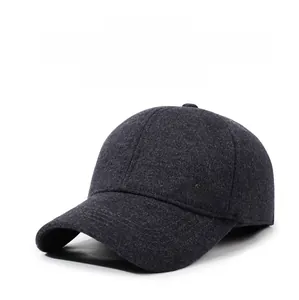 Macro detail of charcoal grey wool baseball cap with SPORT SPIRIT metal logo and ear flaps