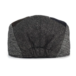 Vintage herringbone newsboy cap in black and gray wool blend shown from the back
