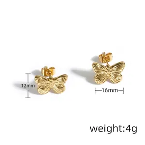 Macro view of gold bow-knot stud earrings showing textured surface and detailed dimensions
