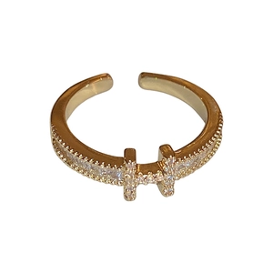 Gold plated adjustable open ring featuring H-shaped design with pavé cubic zirconia