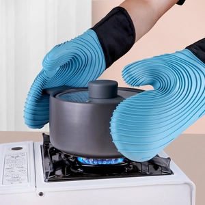 Blue silicone heat-resistant oven mitts with wavy texture and long cuff for cooking.