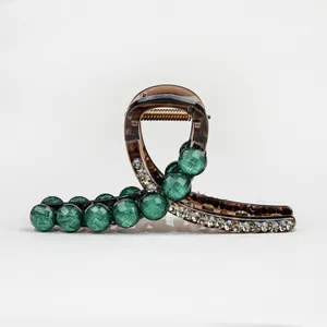 Elegant emerald green bead hair claw clip in translucent resin with sparkling rhinestones