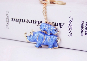 Close-up of blue enamel rhino keychain set with crystal rhinestones and gold-tone hardware