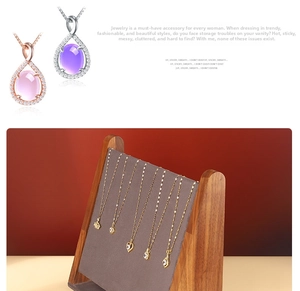 Macro detail of jewelry necklaces on a walnut wood display stand with various pendants