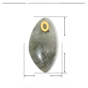 Macro detail of oval green natural stone pendant with gold stainless steel loop
