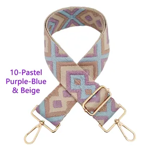 Detail of diamond pattern woven bag strap in purple and light blue with gold metal hooks
