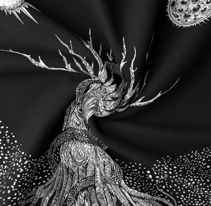 Close-up of soft black fabric with white tree of life and starry sky print details