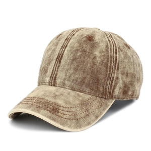 Close-up of vintage washed denim baseball cap with distressed yellow-brown texture