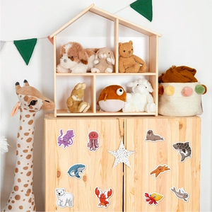Marine animals and polar bear stickers applied on a wooden cabinet in a cozy nursery room