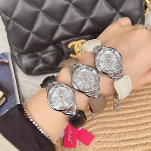 Close-up of three women's watches with snowflake dials in black, brown and white leather