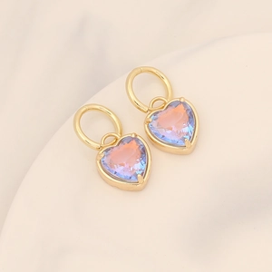 Fashionable 18K gold-plated heart earrings with purple gradient stone on a white background
