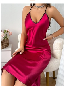 Detail showing the glossy dark rose pink satin fabric and black contrast V-neck trim