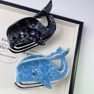 Macro detail of whale hair claw clip with blue marble acetate texture and small rhinestone